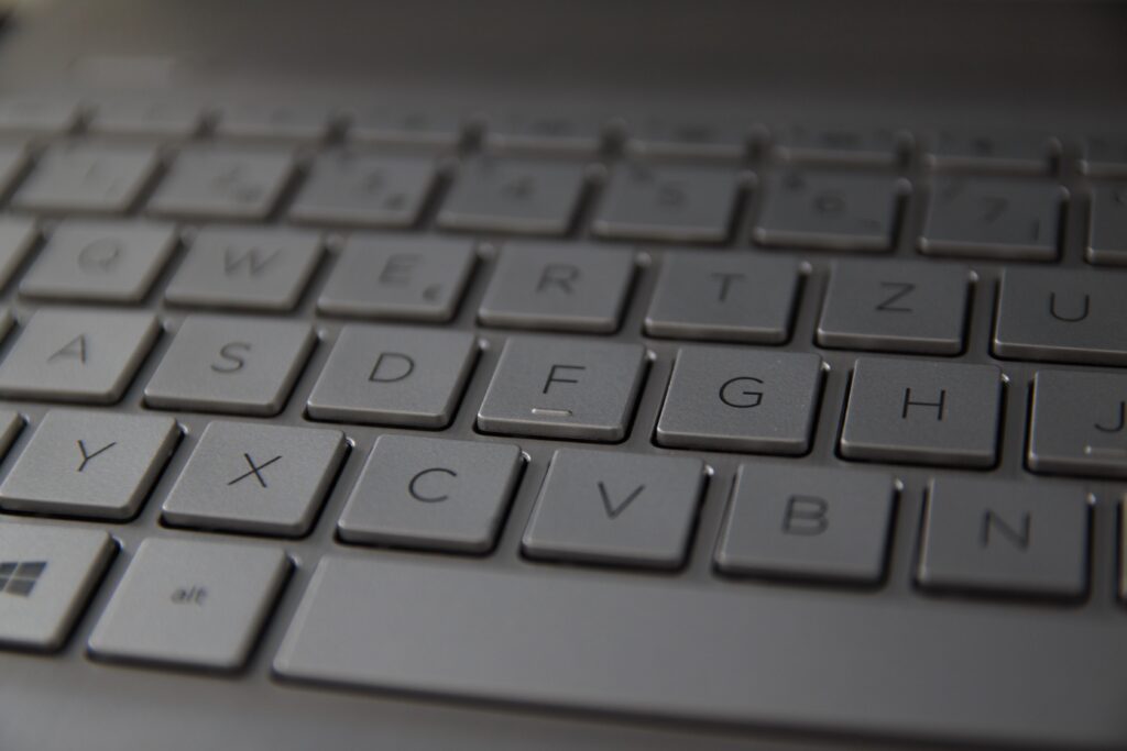 Detailed close-up of a sleek metallic German keyboard with QWERTZ layout.